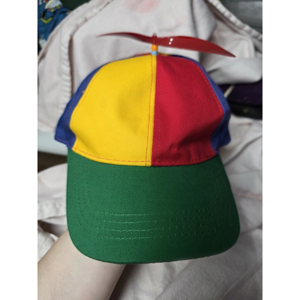Colorful rainbow propeller hat featuring bright red, yellow and blue panels